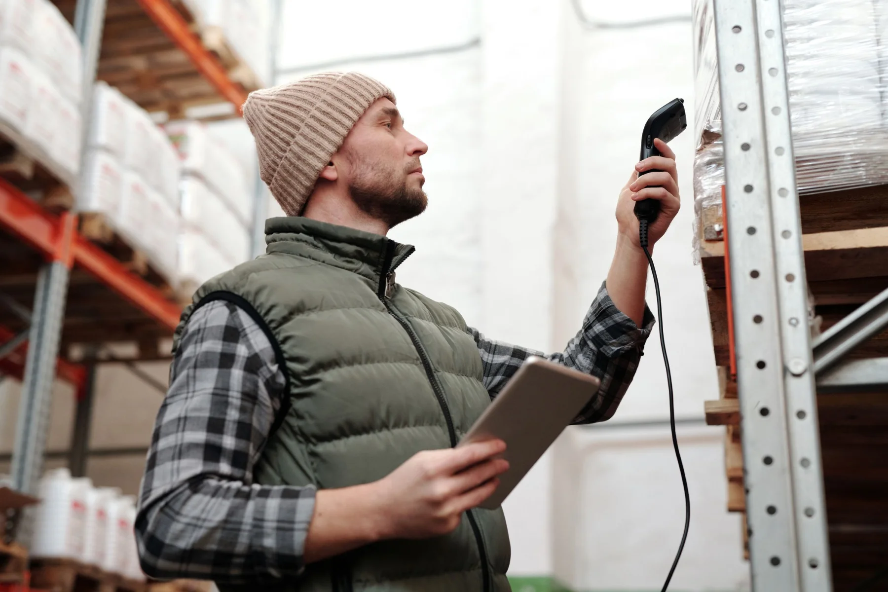 A warehouse operator working with a scanner and tablet
