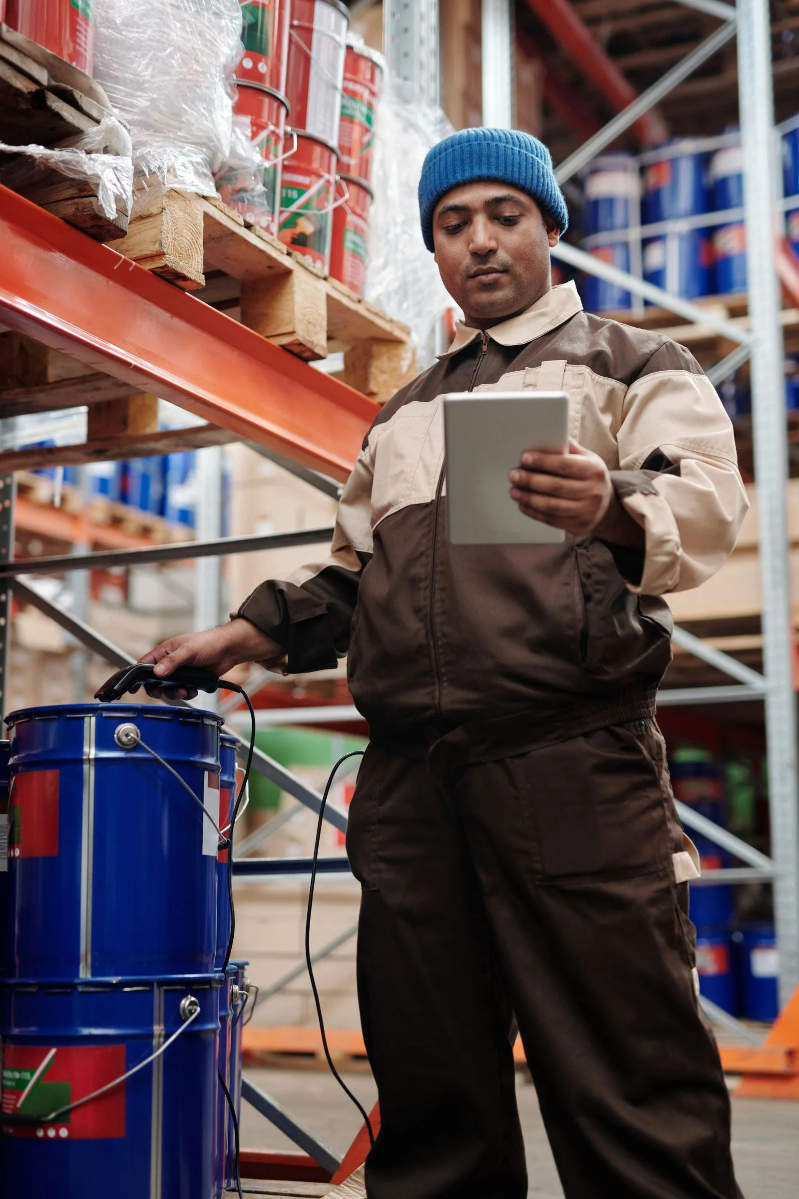 A warehouse professional working with operational data on a tablet