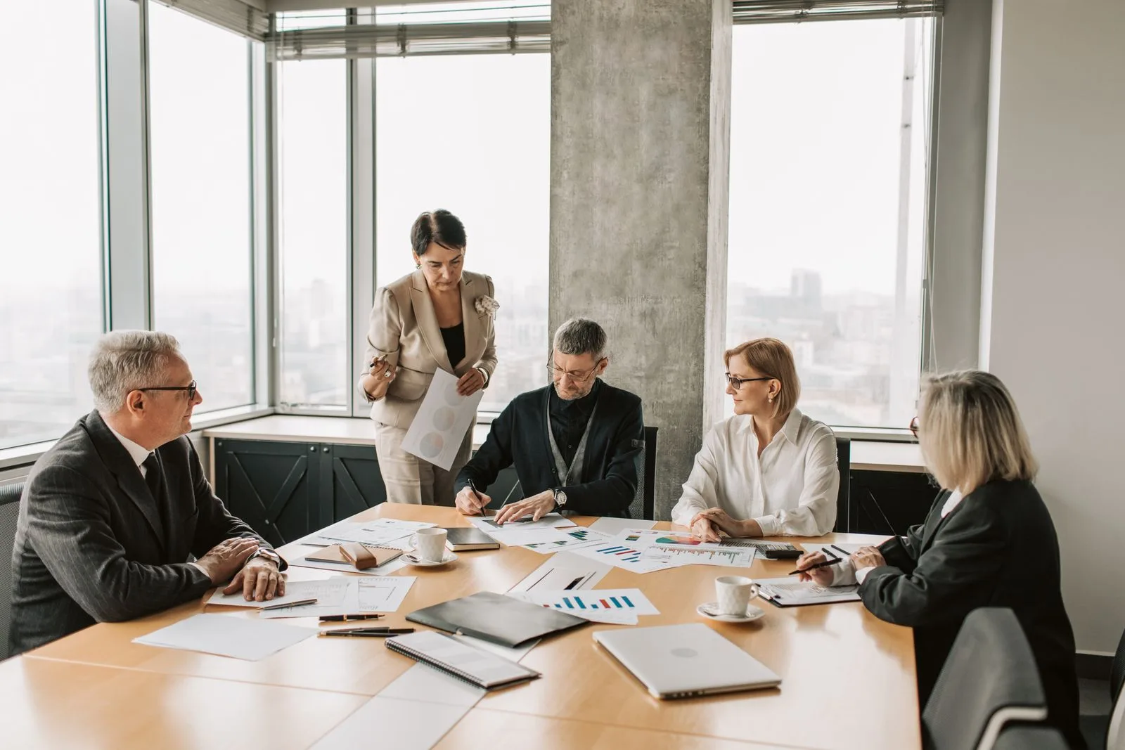 Professionals discussing documents in a modern office