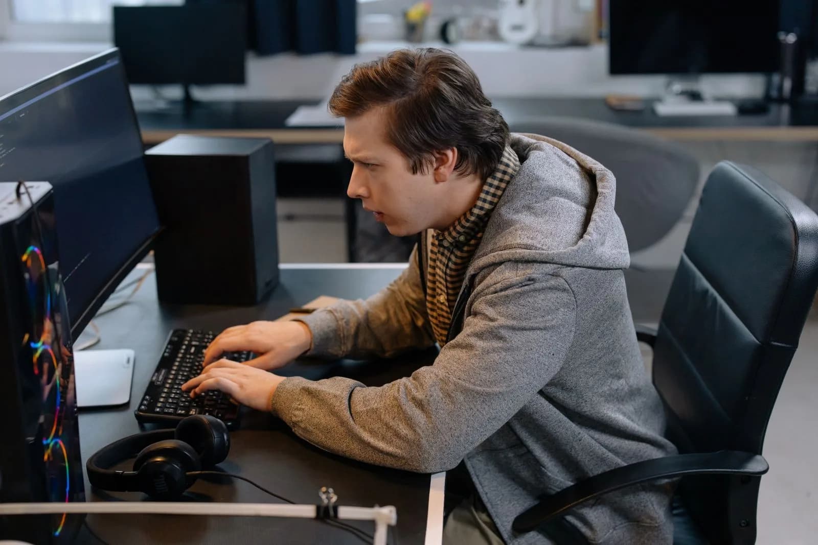 A programmer concentrating at a technical workstation