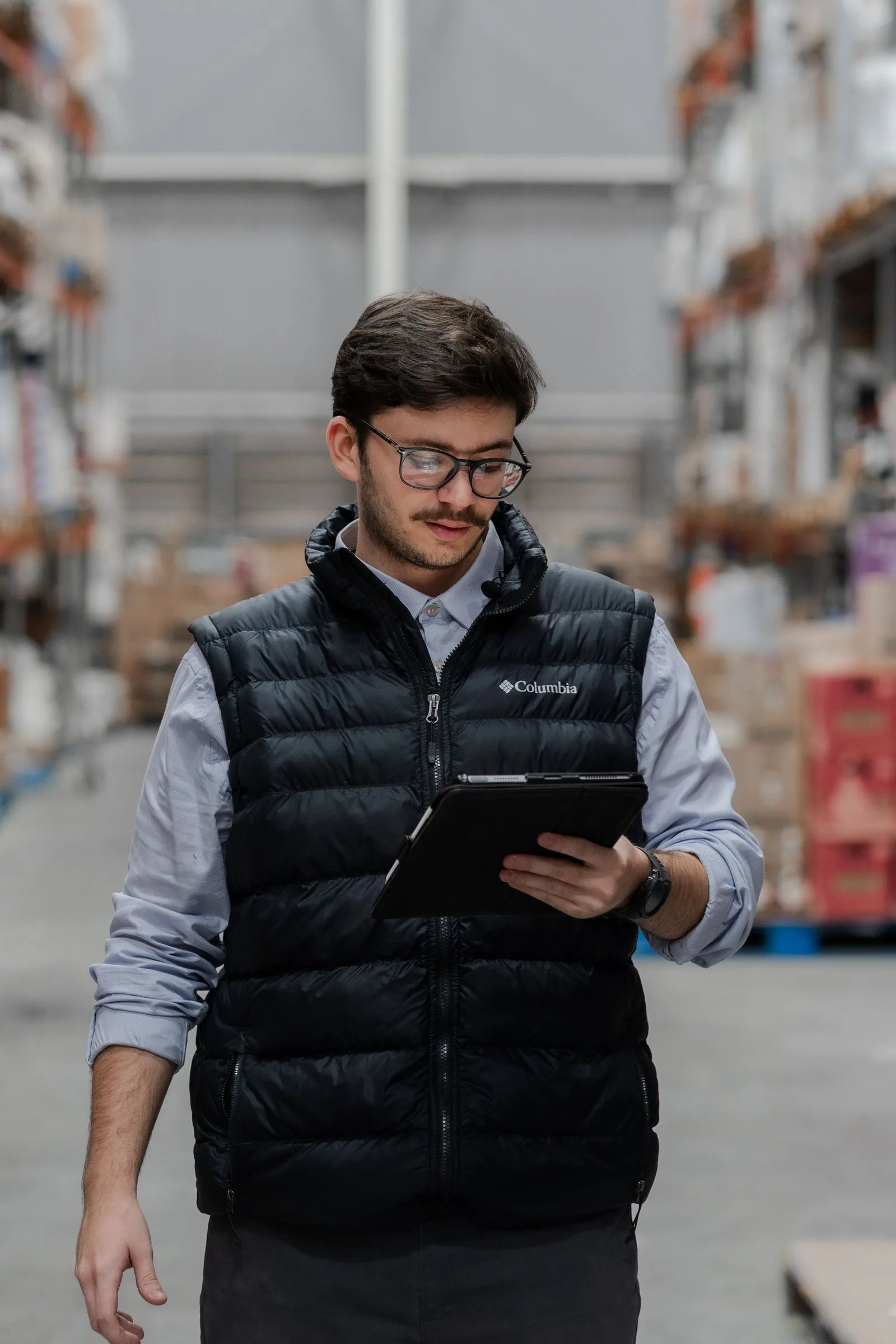 An operations professional reviewing work on a tablet