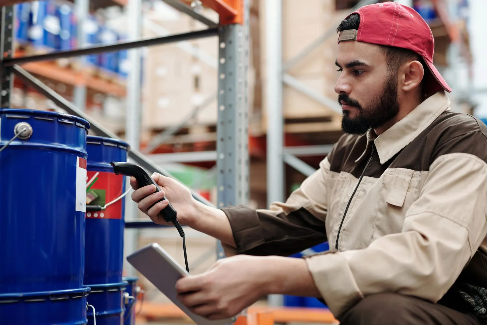 A warehouse worker using a scanner in an industrial operation