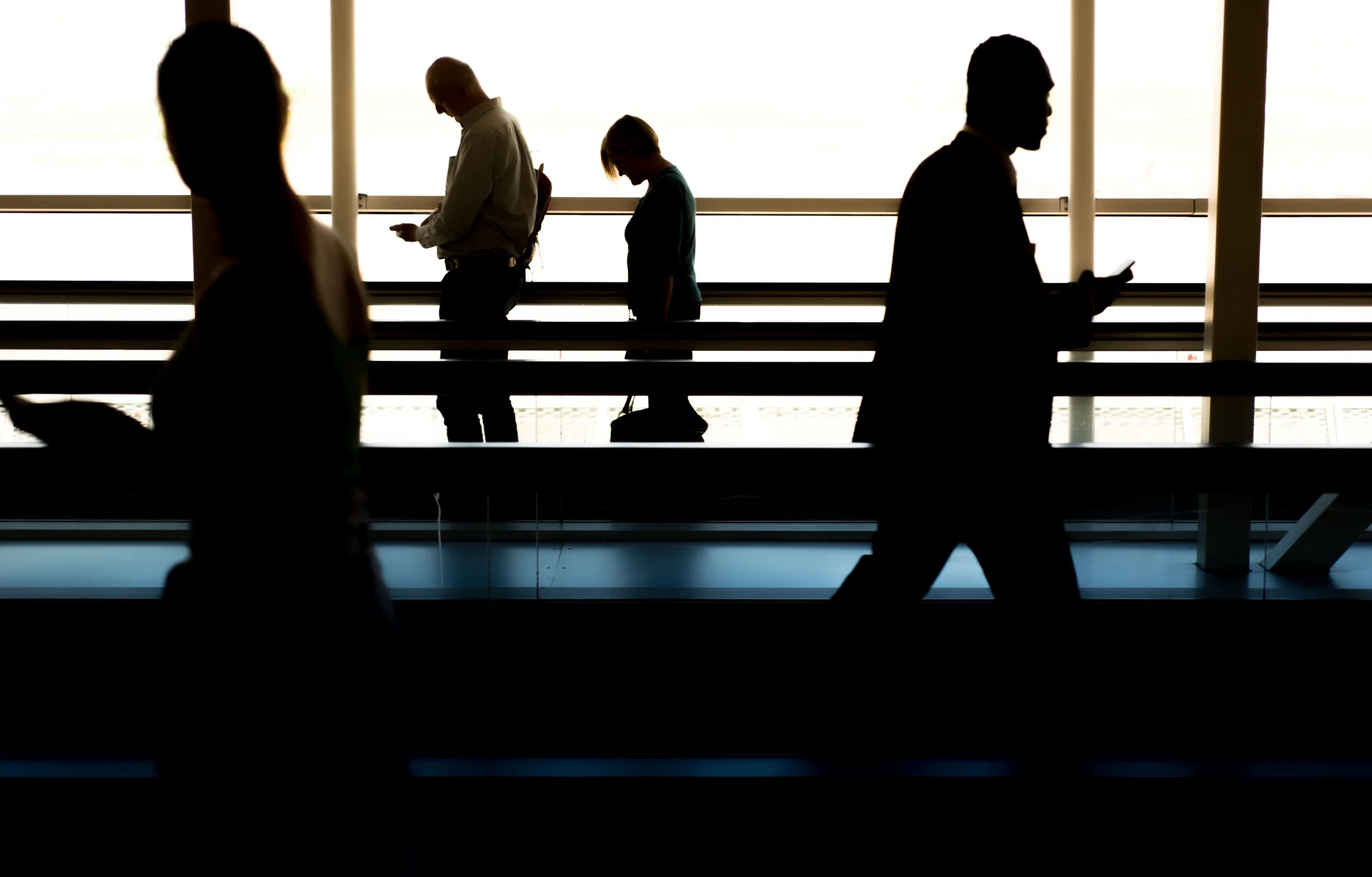 People moving through a bright public concourse