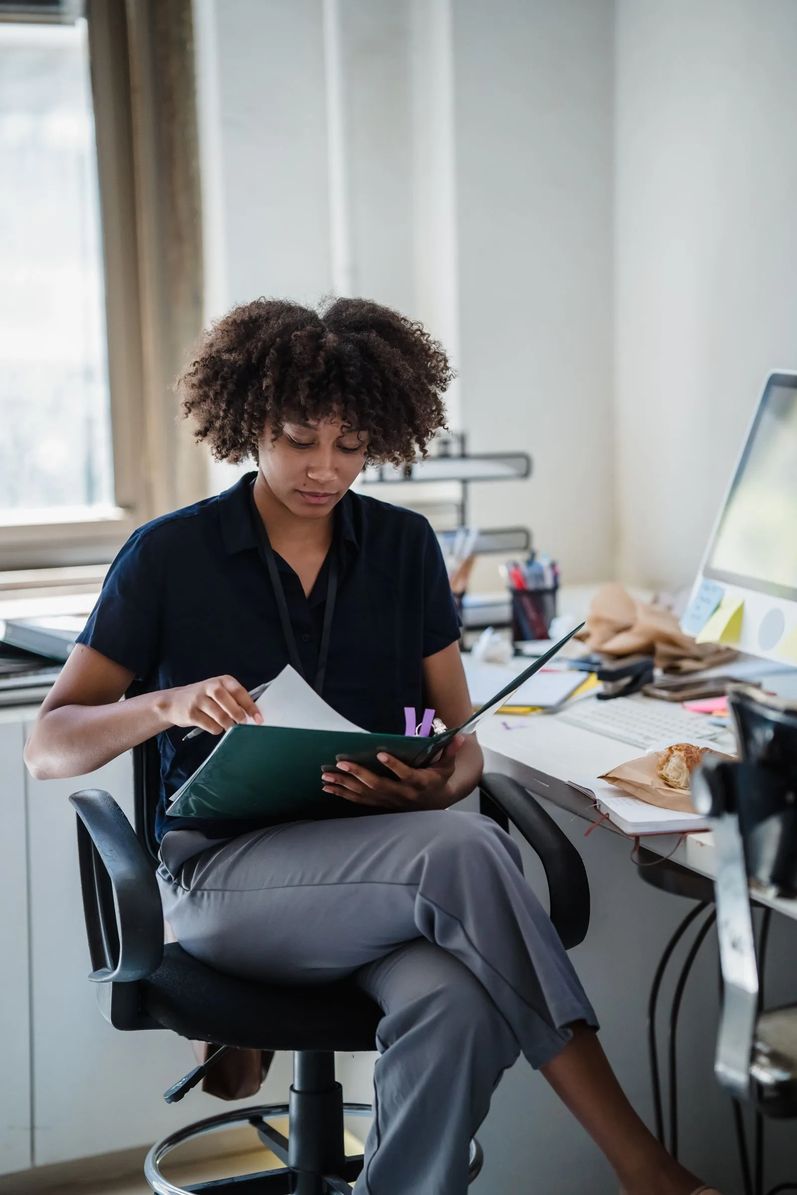 A professional reviewing documentation in a modern office